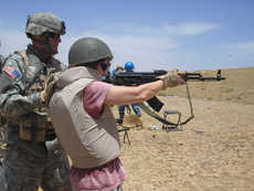 Shelby Monroe, a reporter embedded with U. S. Troops in Iraq, learns how to fire an assault rifle.